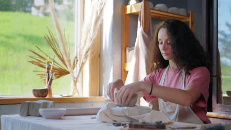 woman potter working on clay