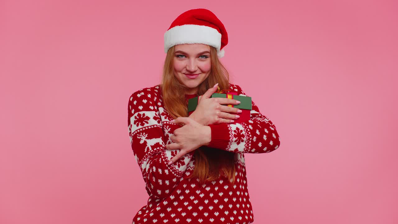 Funny girl wears new year sweater deer antlers received present interested in what inside gift box