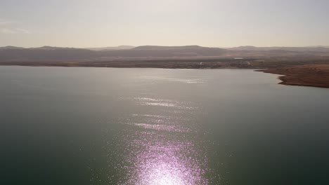aerial view of a calm lake with reflections and mountains