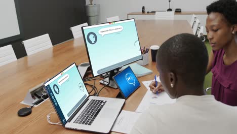 Composition-of-diverse-businesswomen-using-laptop-with-ai-chat-on-screen