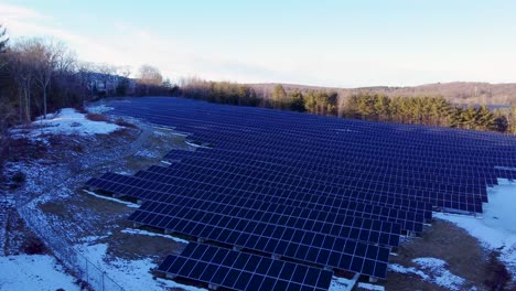 4k aerial view of solar panel farm converting solar power to electricity for green energy