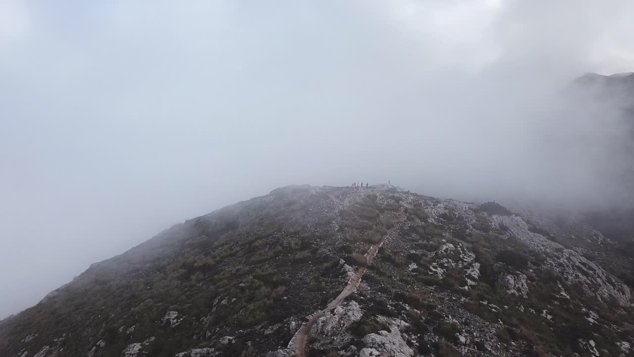 Aerial view through the clouds towards Puig Gros summit, Mallorca, Spain, on a moody day