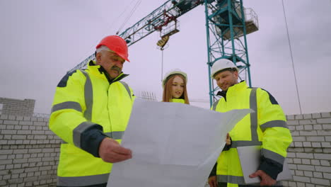 foreman architect and building inspector are examining construction plan three civil engineers