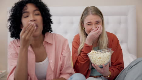 television, comic and women friends on a bed