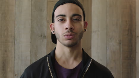 close-up-portrait-of-confident-young-hispanic-man-student-wearing-cool-trendy-fashion-looking-serious-at-camera