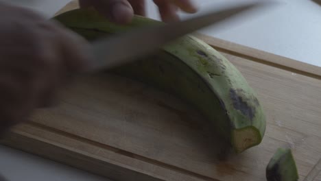 cutting banana plantains in big pieces to boil