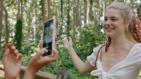 travel woman posing for photo with monkey sitting on shoulder best friend using smartphone photographing playful monkeys sharing wildlife adventure