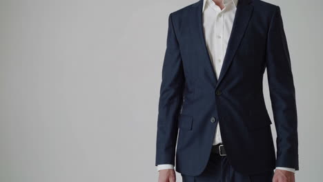 close-up of a person in a dark suit and white shirt