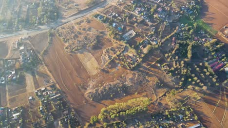 sunrise- kenya landscape with a village, kilimanjaro and amboseli national park - tracking, drone aerial view