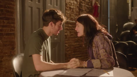 couple of actors holding hands and yelling in excitement on theater stage