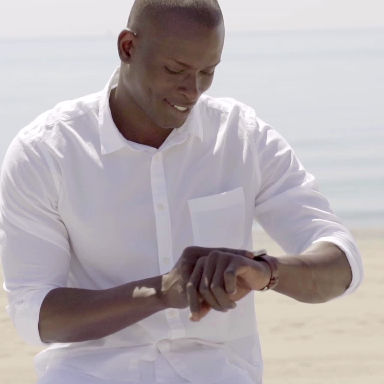 Young man checking the time on his wristwatch