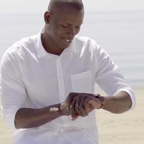 young man checking the time on his wristwatch