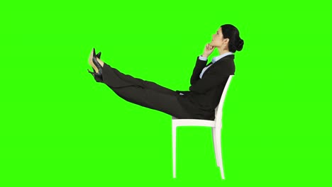 Business-woman-relaxing-on-a-chair-with-legs-up