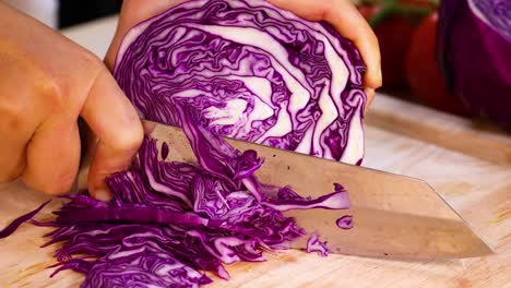 slicing cabbage on a wooden cutting board