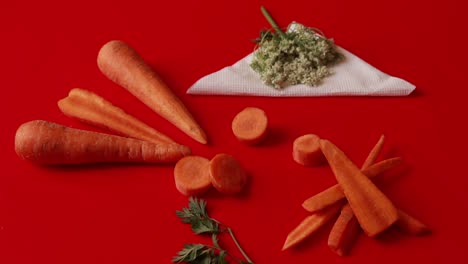 carrot vegetable with leaves isolated on red background cutout