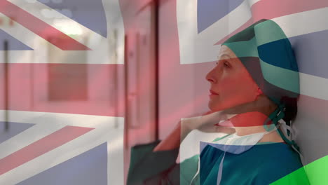 animación de la bandera del reino unido con un trabajador de la salud en el fondo durante la pandemia de coronavirus