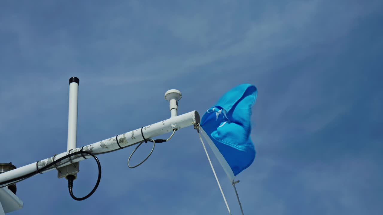 Medium shot of Vasttrafik ferry flag waving during the day, public transport services in Vastra Gotaland County, Sweden