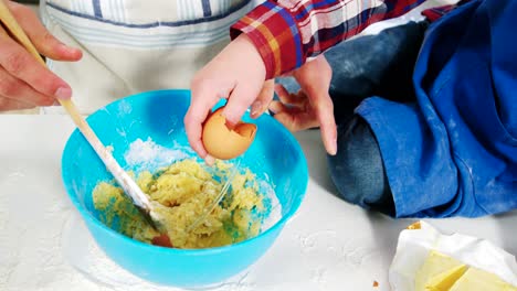 Father-and-son-preparing-cupcake