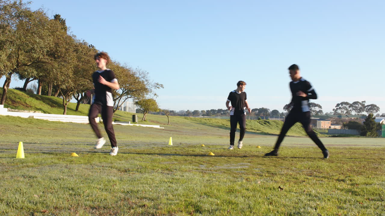 Running on field, boys practicing cricket drills during school sports day