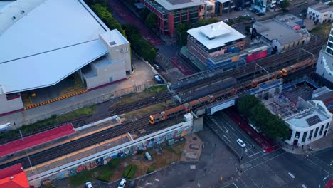 Aerial-view-of-Train-Arriving-At-The-South-Brisbane-Station-near-South-Bank,-Brisbane-City,-Queensland,-Australia