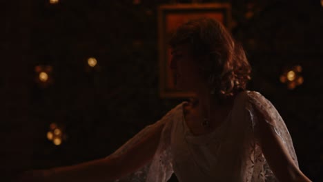 close up of a carefree woman dancing in a church while wearing a wedding dress