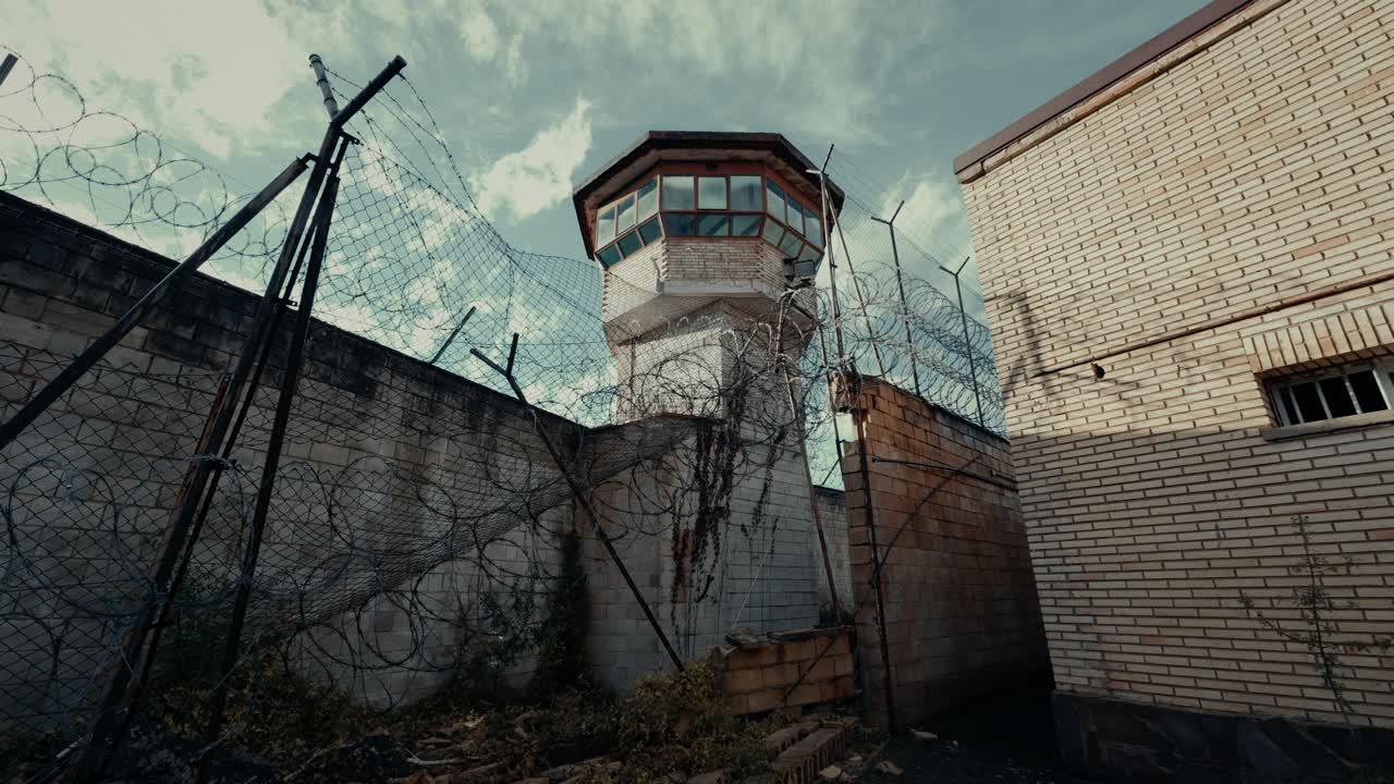 Prison Watchtower with Barbed Wire and High Walls