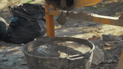 filling bucket with cement slow motion