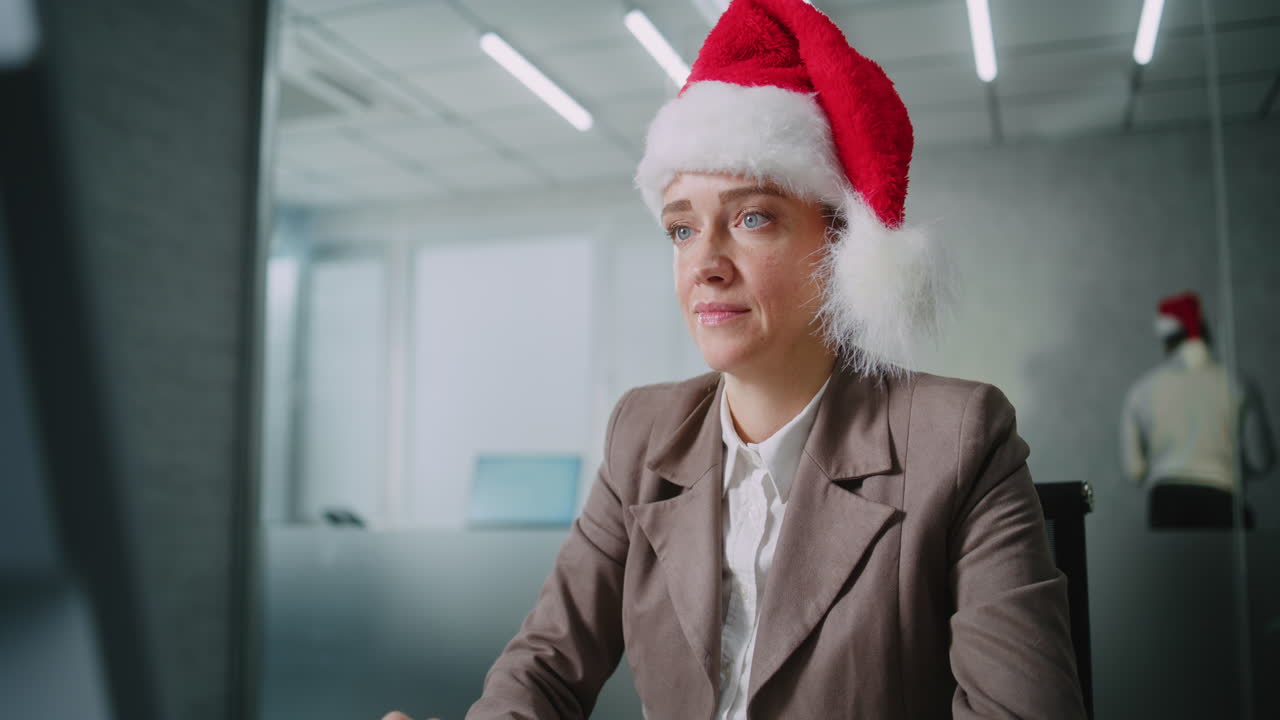 Caucasian Woman in Christmas Hat Works in Modern Office Uses Computer