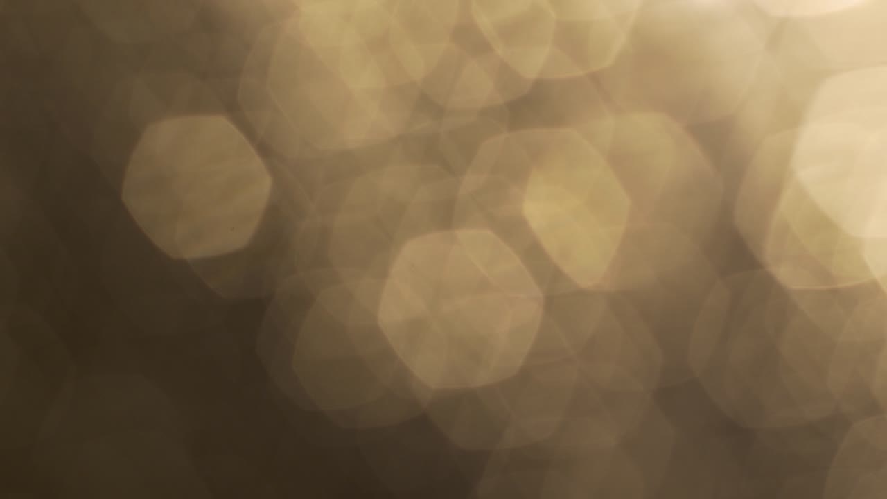 Sfondo di Luci Bokeh Esagonali Dorate Astratte