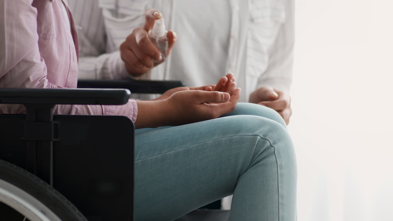 Woman in Wheelchair Receiving Hand Sanitizer