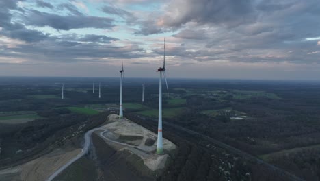 wind tubrine, aerial view. sunset, clean green energy. germany. energy transistion, turning blades, close up view.
