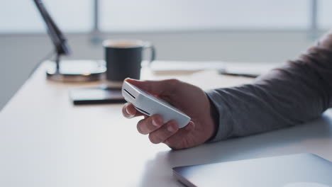 Man-Making-Contactless-Payment-Using-Credit-Card-To-Woman-Holding-Card-Reader