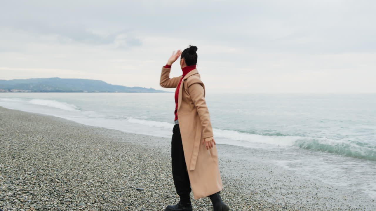 Dance For A Woman With Brown Coat To Get Rid Of Anxieties Near The Ocean