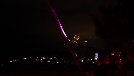 vibrant fireworks illuminate the night sky over karon beach, phuket, capturing a festive atmosphere with spectators enjoying the spectacle
