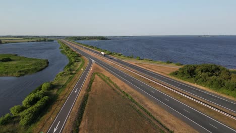 a beautiful road in the middle of the a lake in netherland