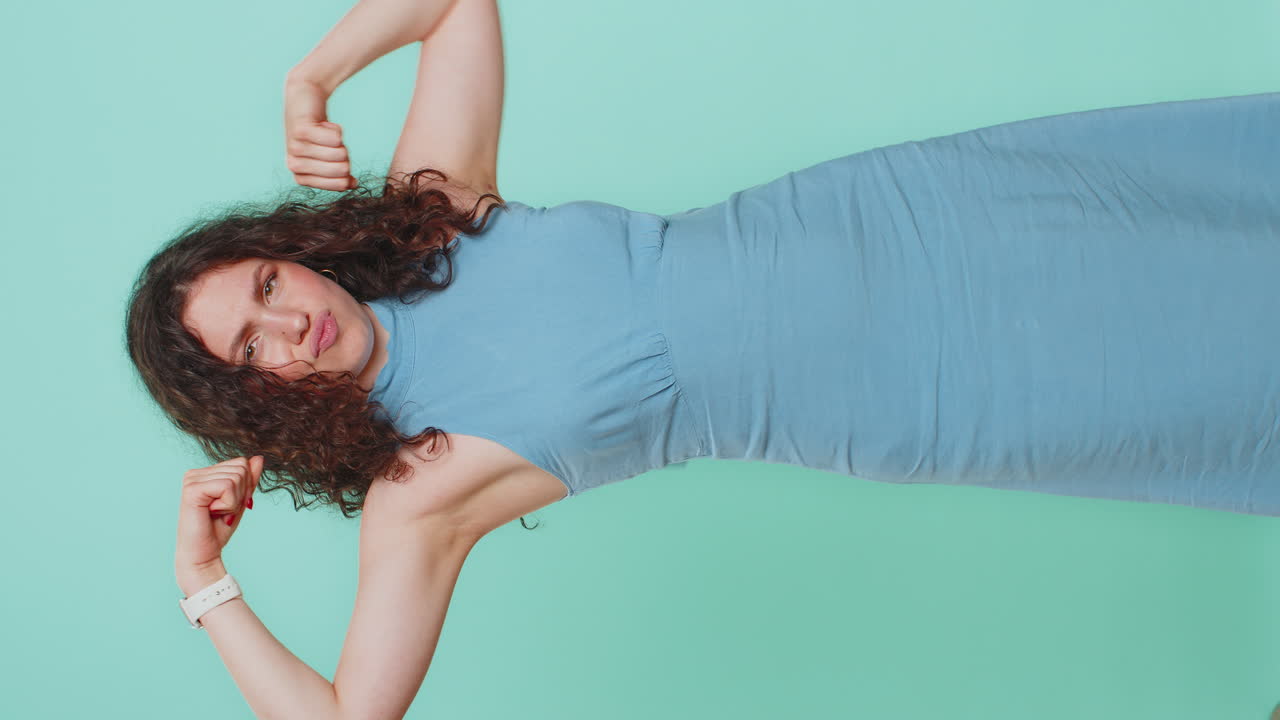 Woman showing biceps and looking confident feeling power strength to fight for rights success win