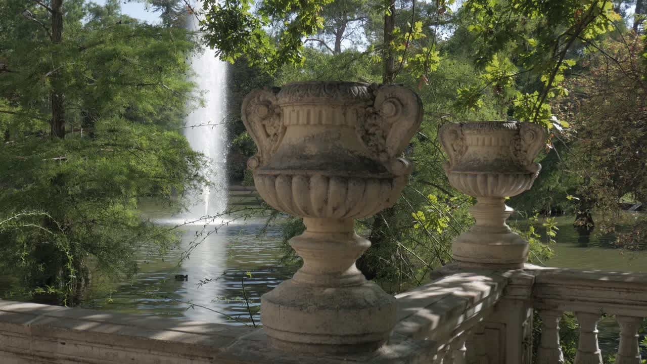 Elegant old stone vases on a terrace by the pond in Retiro Park, Madrid