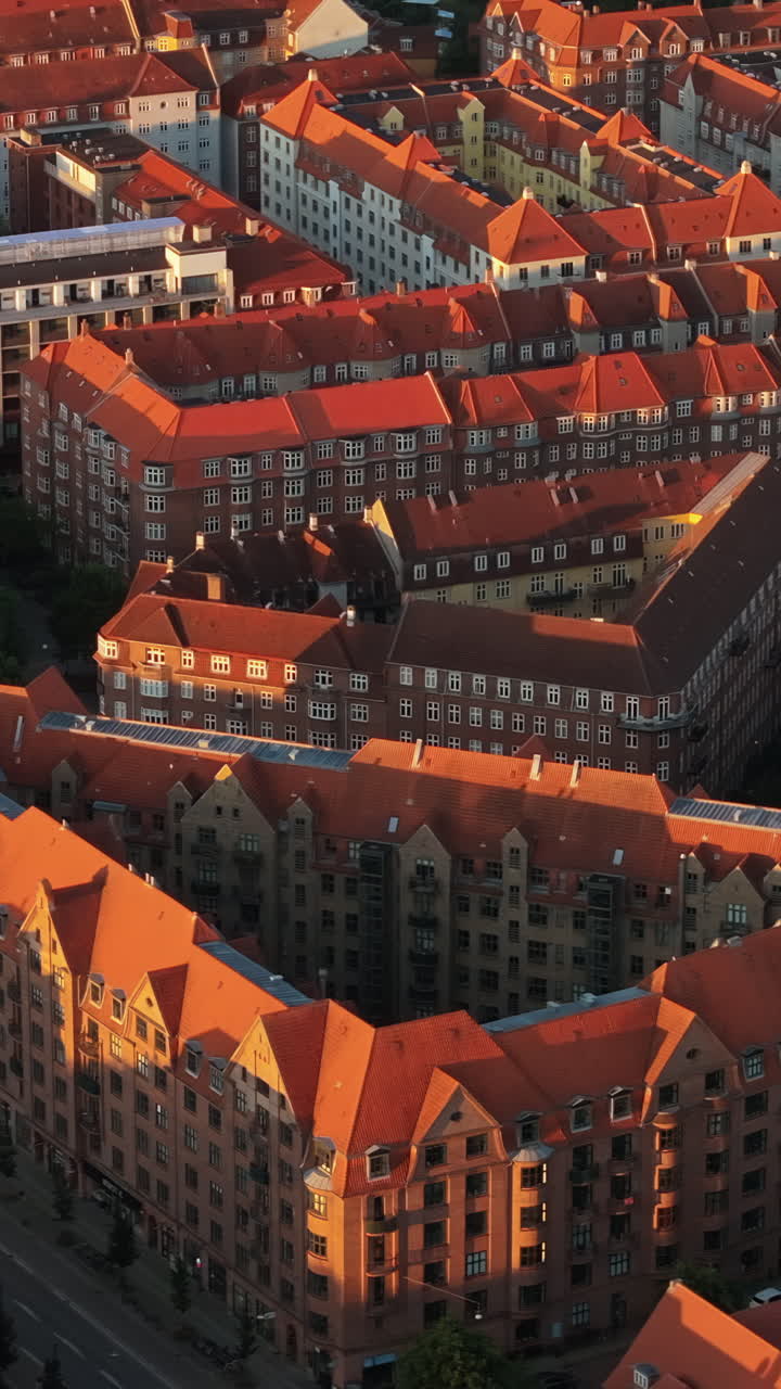 Aerial drone view of Amagerbro area in the northern part of the island Amager in Copenhagen, Denmark at sunset. Vertical