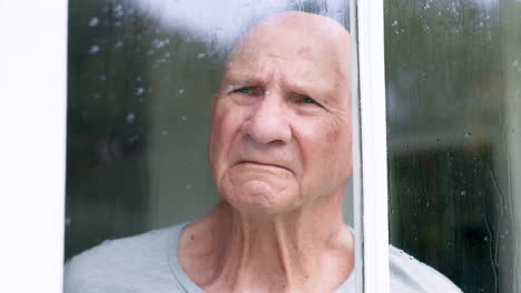 sad, window and senior man at a retirement