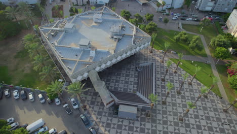 Top-down-view-The-old-city-hall-of-Bat-Yam,-Israel---The-building-built-between-1960-1963-and-was-exposed-to-the-coastline,-around-the-city-hall-there-is-a-public-square-for-the-public