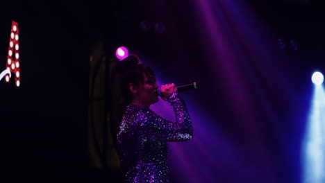 woman singing on stage at a concert