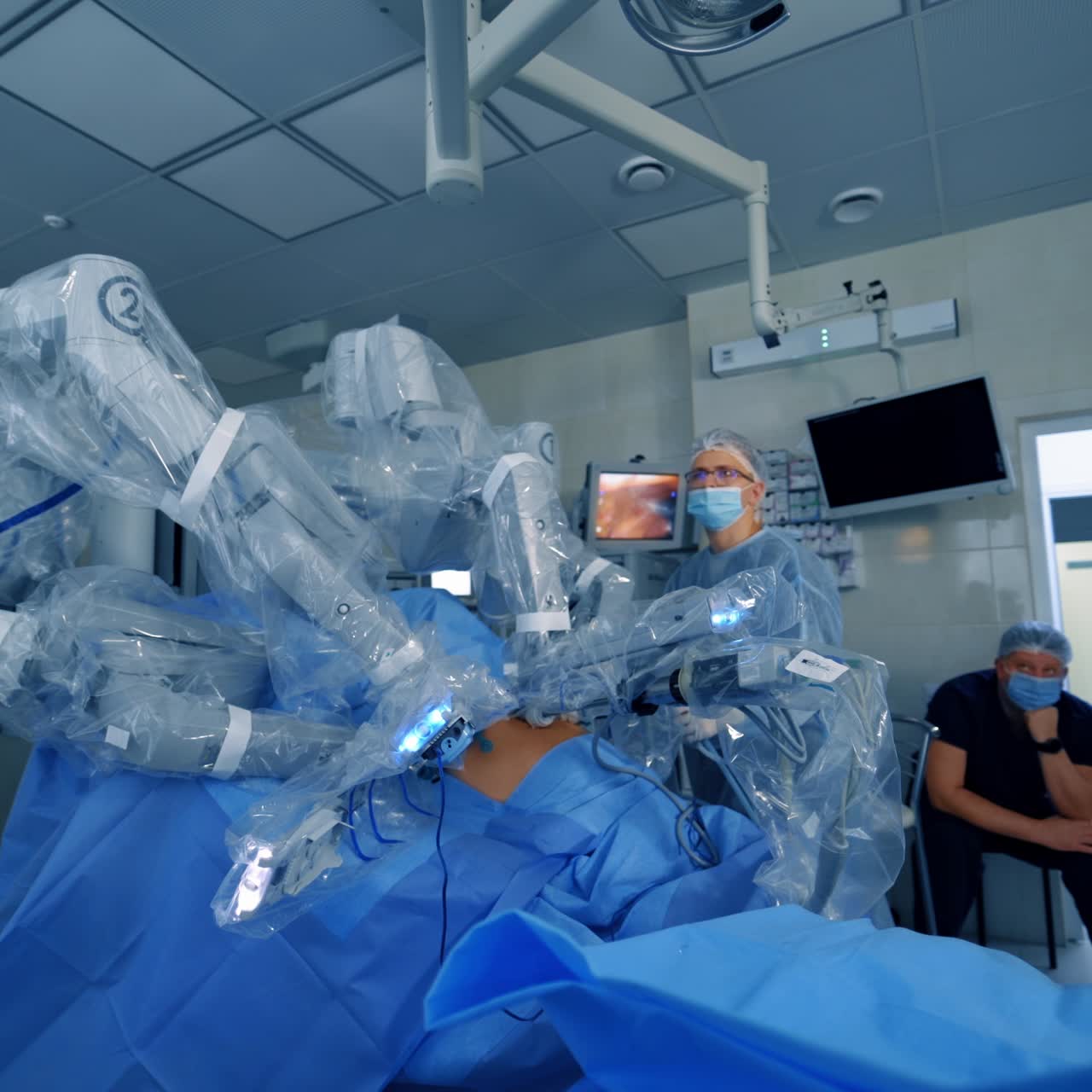 Modern robot in the operating room. Innovative arms of a robotic equipment perform an operation. Minimally invasive surgical innovation in medicine.