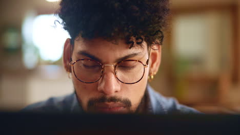 hombre concentrado trabajando en una computadora portátil