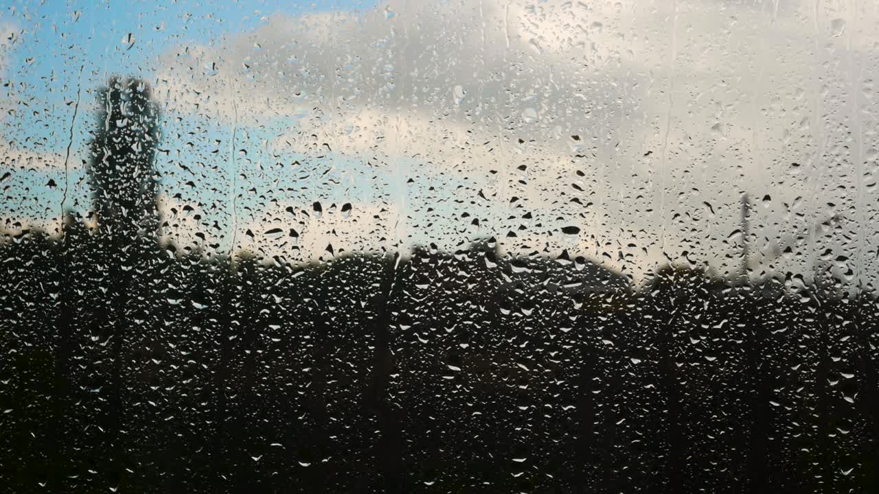 Raindrops on glass, beautiful rainy day. Drop texture. Rain outside the window