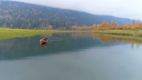 man rowing a boat on a lake 4k