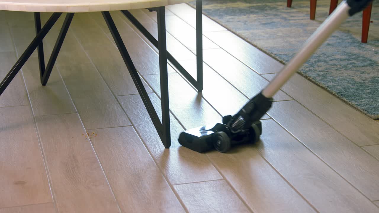 vacuuming tiled floor close-up