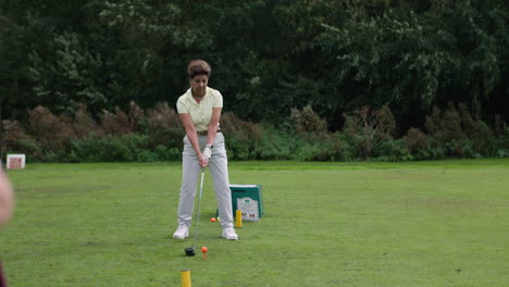 a woman playing golf on a golf course