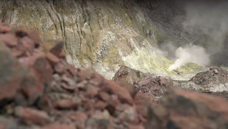 Volcanic rock on Whakaari white island, focus pull to sulfur slope