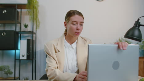 business smiling woman closing laptop computer after finishing online work remote job, home office