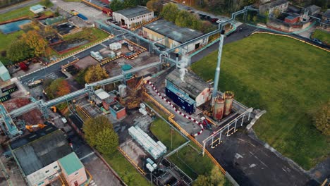 futuristic industrial looking aerial drone footage, with a steampunk look with industrial buildings and vehicles